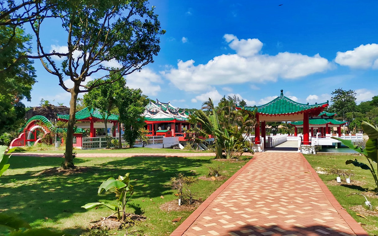 Kusu Island temple with green roofs and red pillars, Singapore.