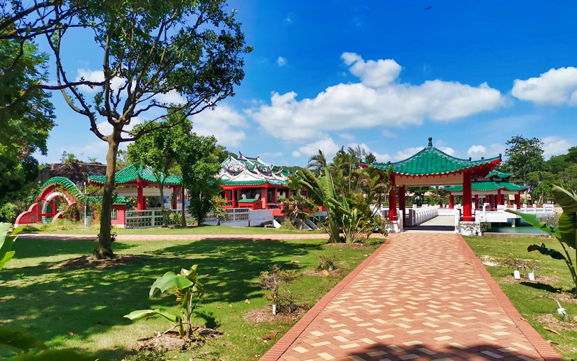 Kusu Island temple with green roofs and red pillars, Singapore.