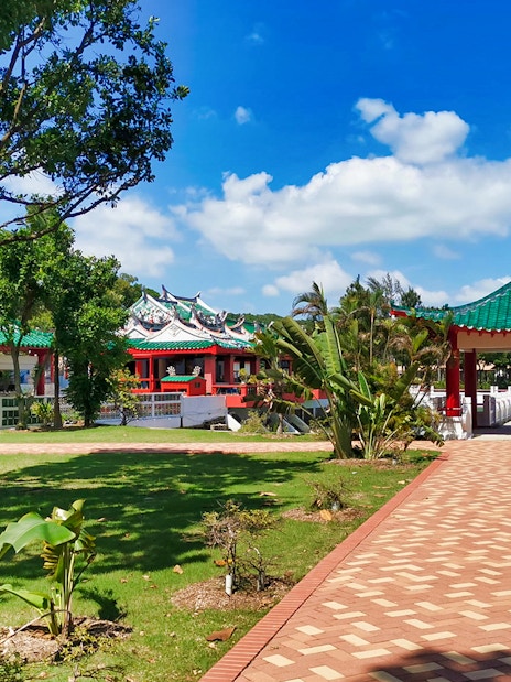 Kusu Island temple with green roofs and red pillars, Singapore.