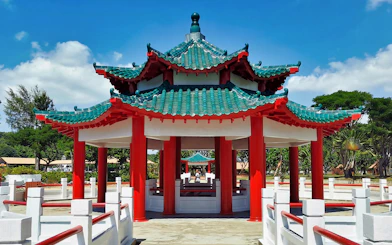 Pagoda on Kusu Island, Singapore, with red pillars and green tiled roof.