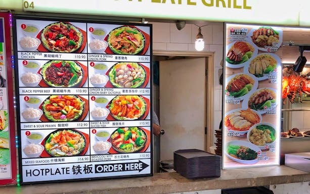 Menu board at Satay by the Bay, Gardens by the Bay, featuring various Asian dishes.