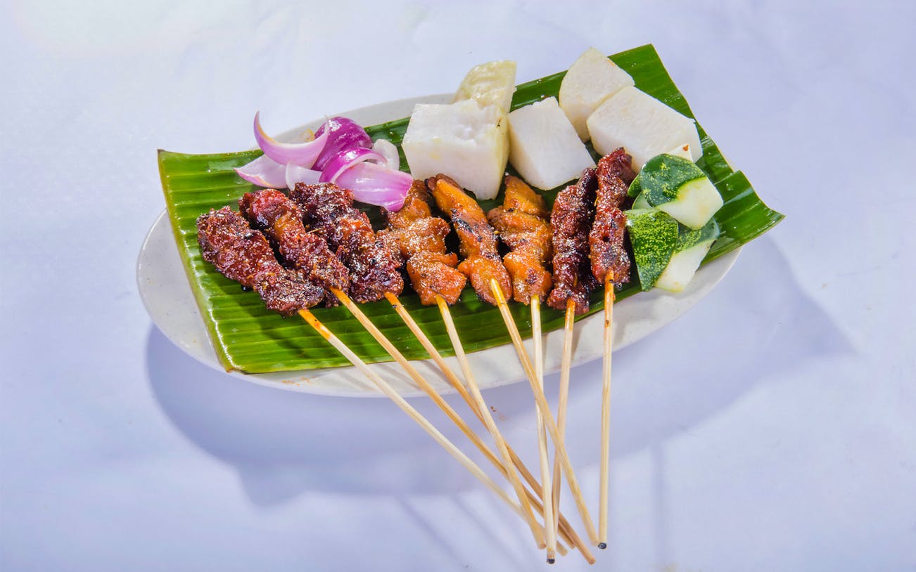 Satay skewers with onions and rice cakes at Satay by the Bay, Gardens by the Bay, Singapore.