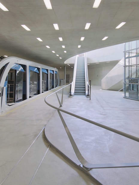 Funicular station interior with modern design, featuring the Hungerburgbahn train in Innsbruck.