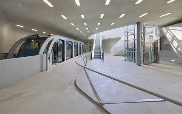Funicular station interior with modern design, featuring the Hungerburgbahn train in Innsbruck.