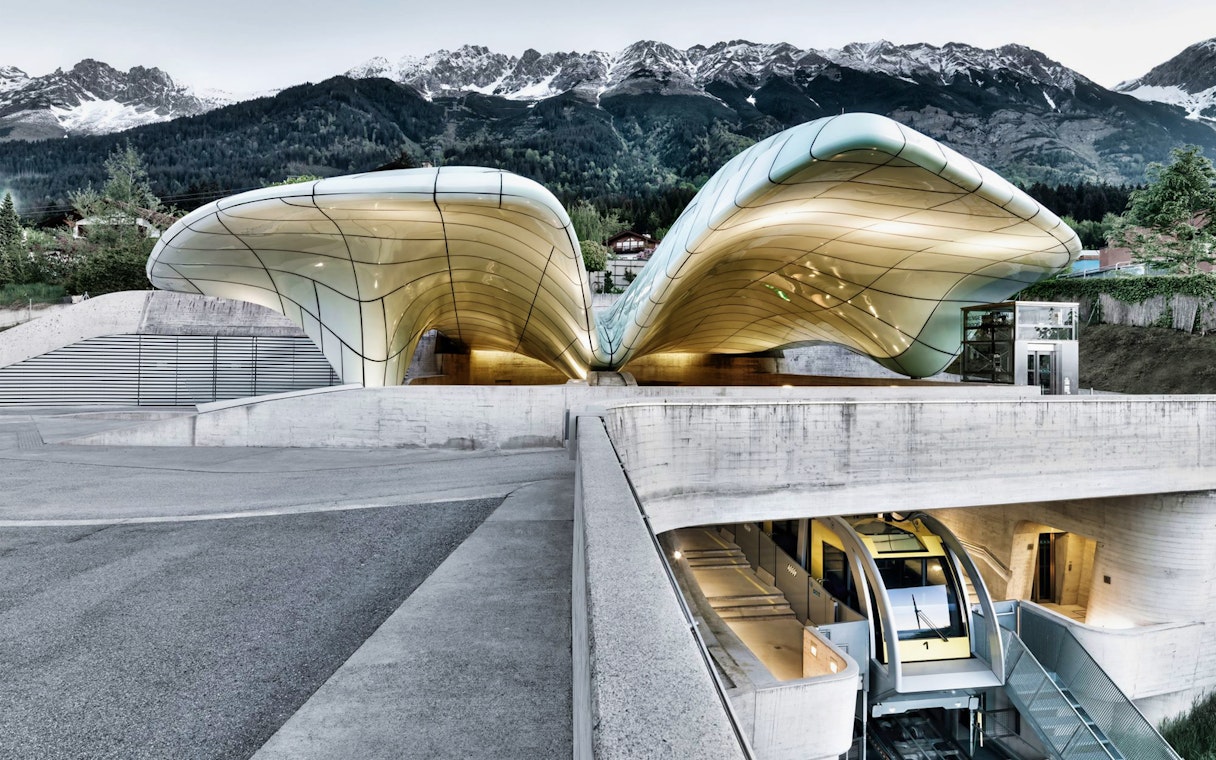 Hungerburgbahn funicular station with modern architecture and mountain backdrop in Innsbruck.