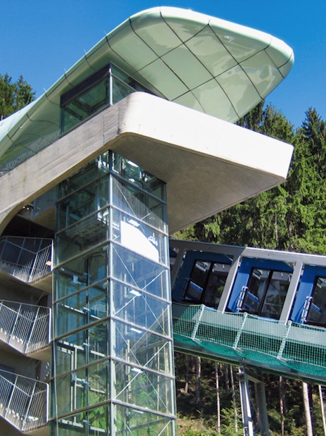 Funicular ascending to Hungerburgbahn station surrounded by forest.