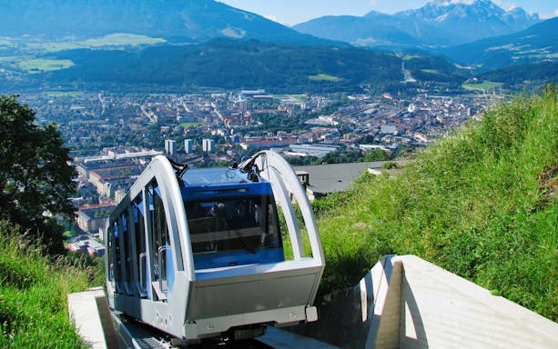 Funicular ascending to Hungerburgbahn with Innsbruck city view.