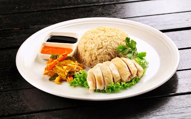 Hainanese chicken rice with sauces at a dining spot in Sentosa or Mount Faber.