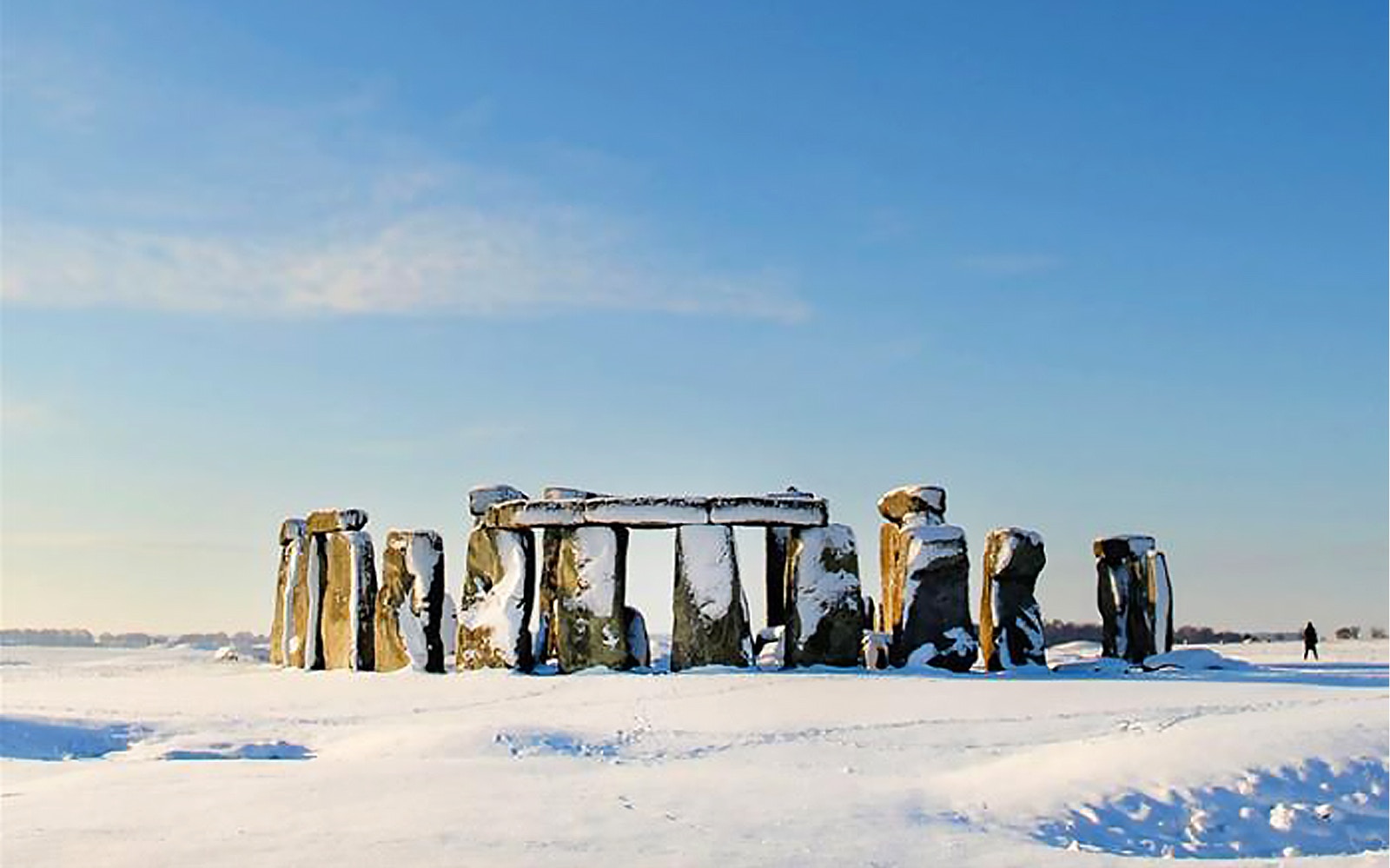 Stonehenge covered in snow during a Boxing Day tour in Wiltshire, England.