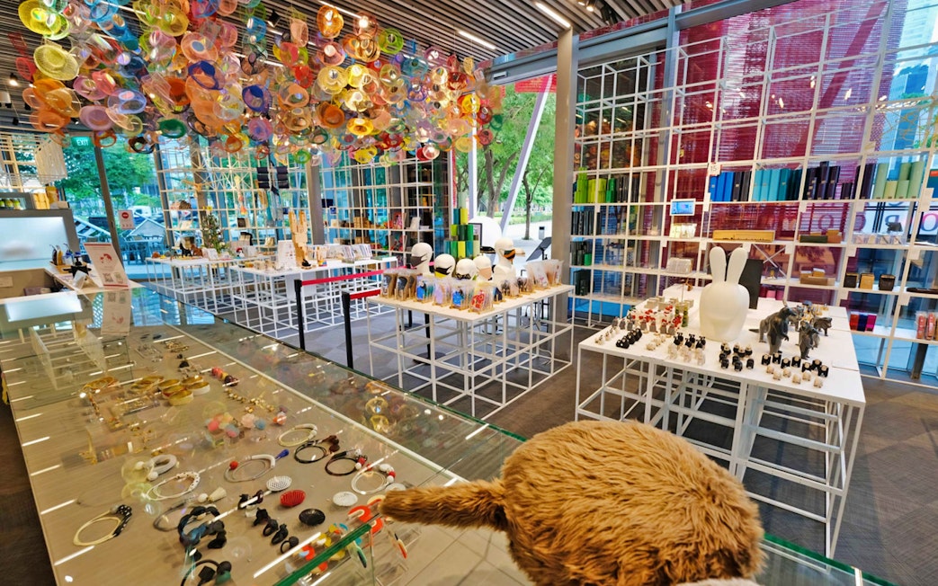 Red Dot Design Museum interior with colorful ceiling art and display of unique gifts in Singapore.