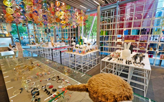 Red Dot Design Museum interior with colorful ceiling art and display of unique gifts in Singapore.