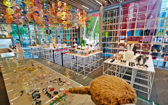 Red Dot Design Museum interior with colorful ceiling art and display of unique gifts in Singapore.