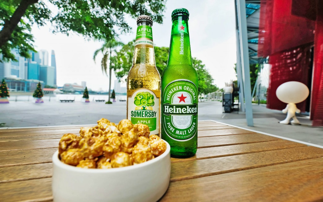 Bottles of cider and beer with caramel popcorn at Red Dot Design Museum, Singapore.
