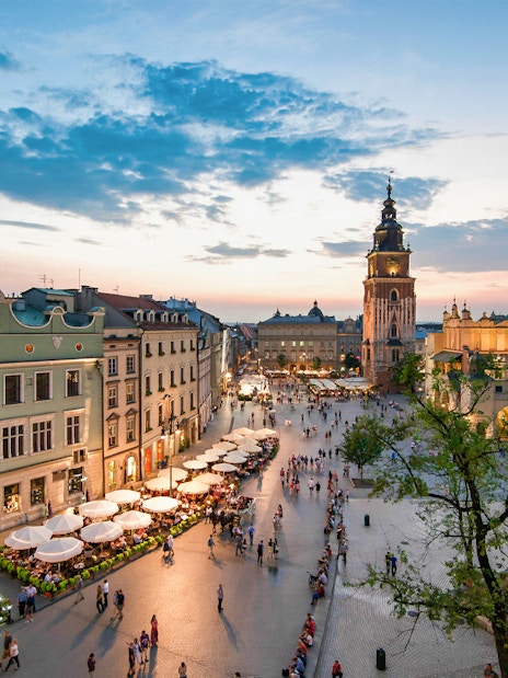 Krakow's Main Square at sunset with St. Mary's Basilica and Cloth Hall.