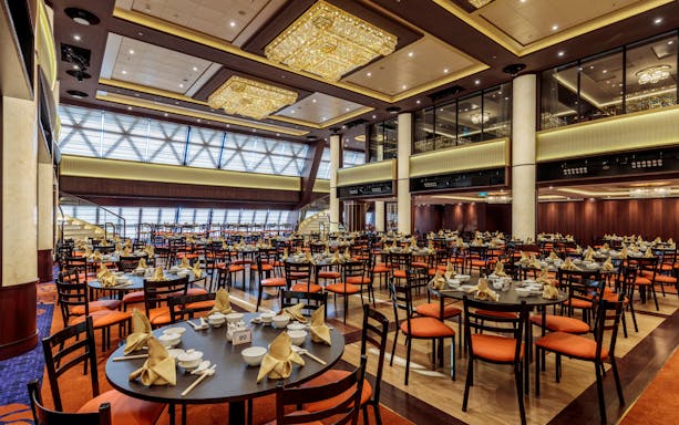 Luxurious dining hall on World Dream Getaway Cruise with elegant table settings.