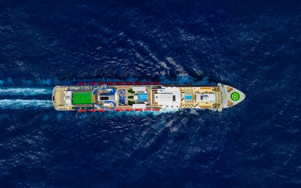 Aerial view of cruise ship on World Dream Getaway Cruise sailing through ocean.