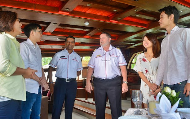 Guests interacting with crew members aboard The Royal Albatross sail.
