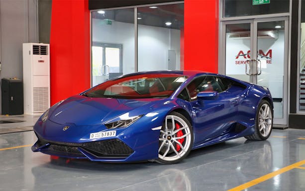 Blue luxury supercar parked indoors for driving experience in Dubai.