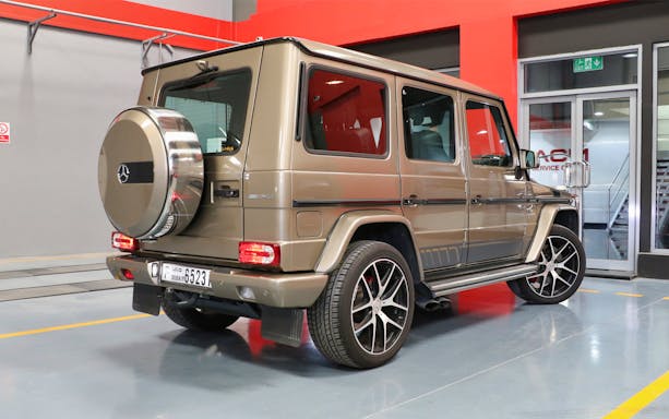 Luxury SUV parked indoors for supercar driving experience in Dubai.