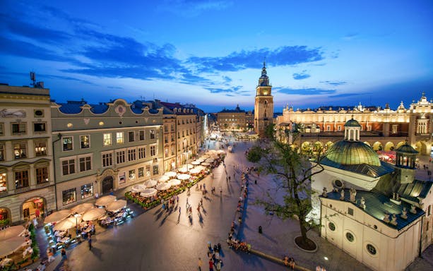 Krakow Main Square at dusk with St. Mary's Basilica and Cloth Hall, view from above.