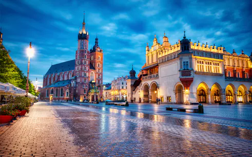 Krakow's Main Square at dusk with St. Mary's Basilica and Cloth Hall.
