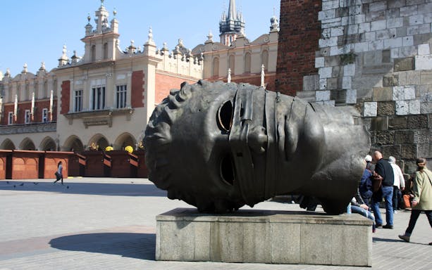 Krakow bike tour passing by the Eros Bendato sculpture in Market Square.