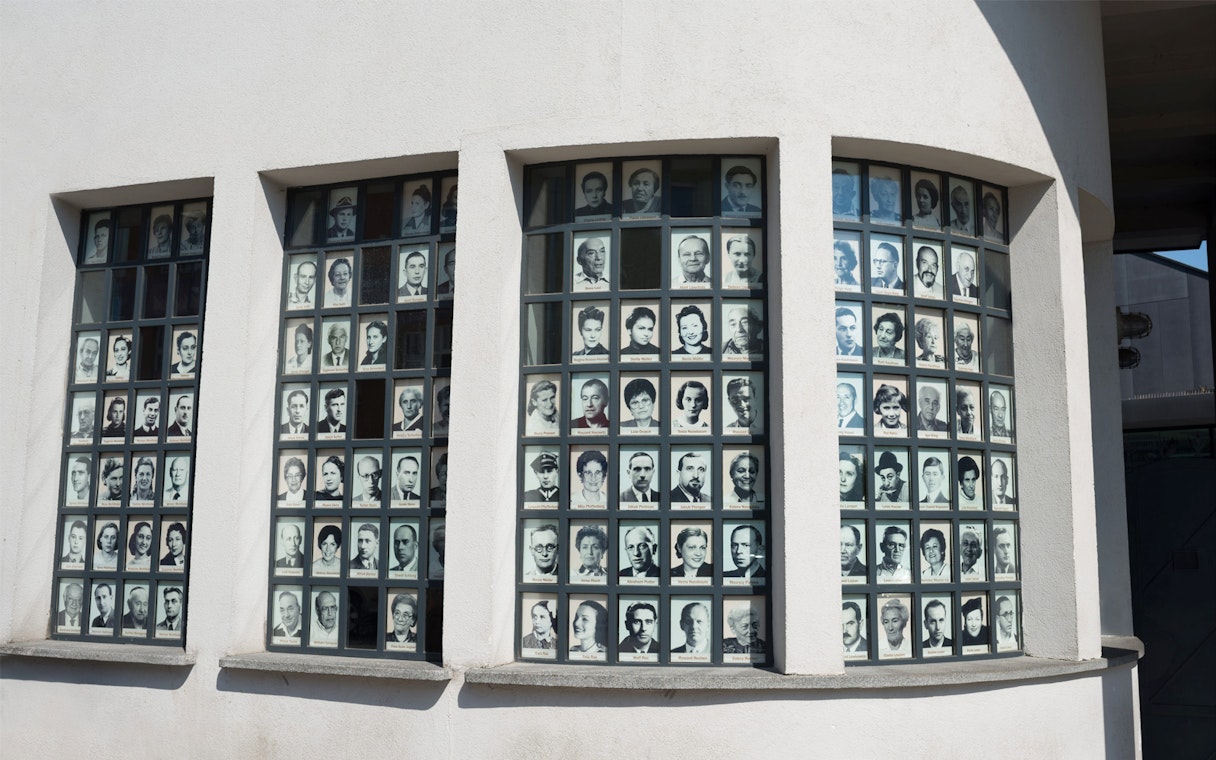 Photos of Holocaust survivors displayed on Oskar Schindler's Factory windows in Krakow.