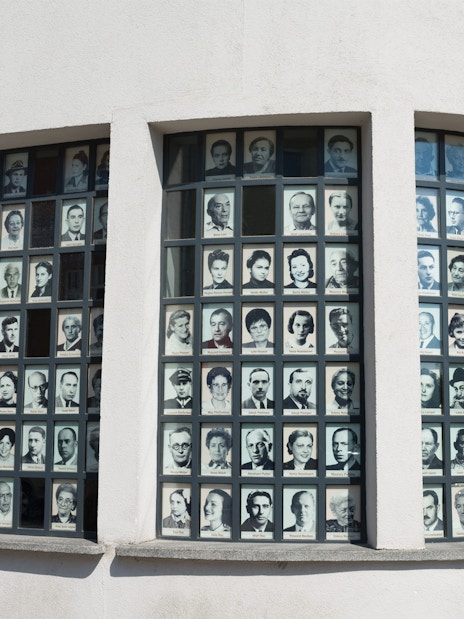 Photos of Holocaust survivors displayed on Oskar Schindler's Factory windows in Krakow.