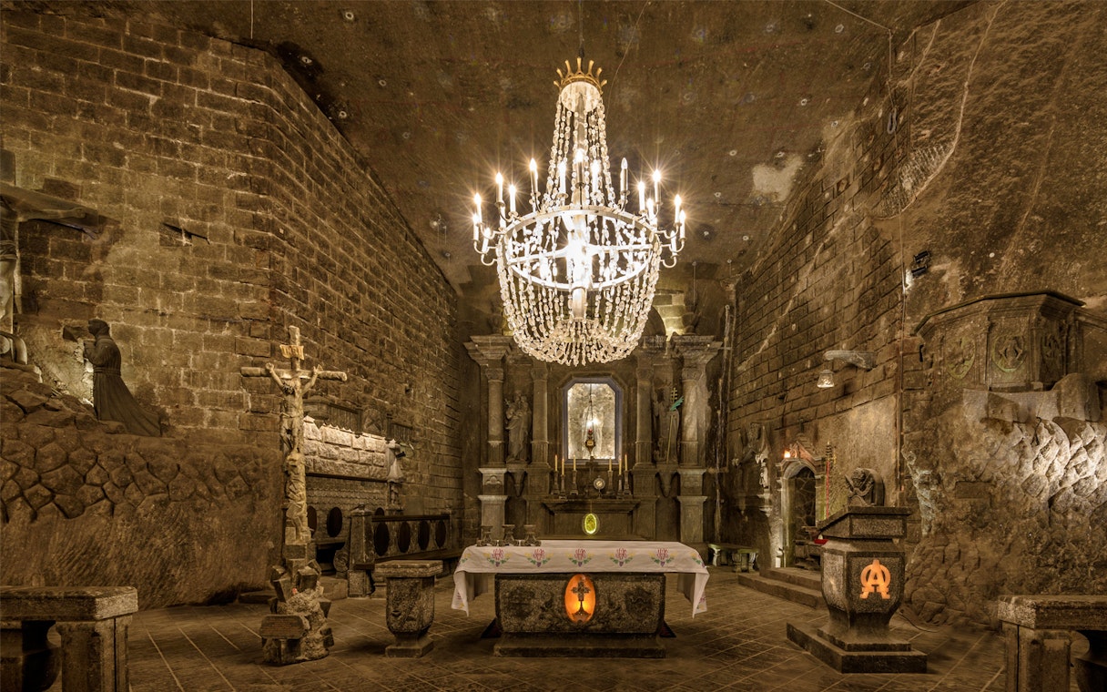 Wieliczka Salt Mine chapel with ornate chandelier and altar, Krakow tour.