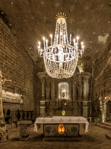 Wieliczka Salt Mine chapel with ornate chandelier and altar, Krakow tour.