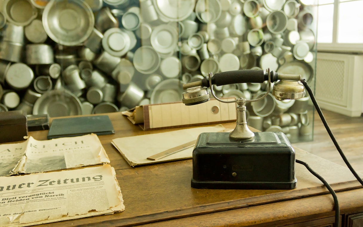 Old telephone and newspapers at Oskar Schindler's Factory exhibit in Krakow.