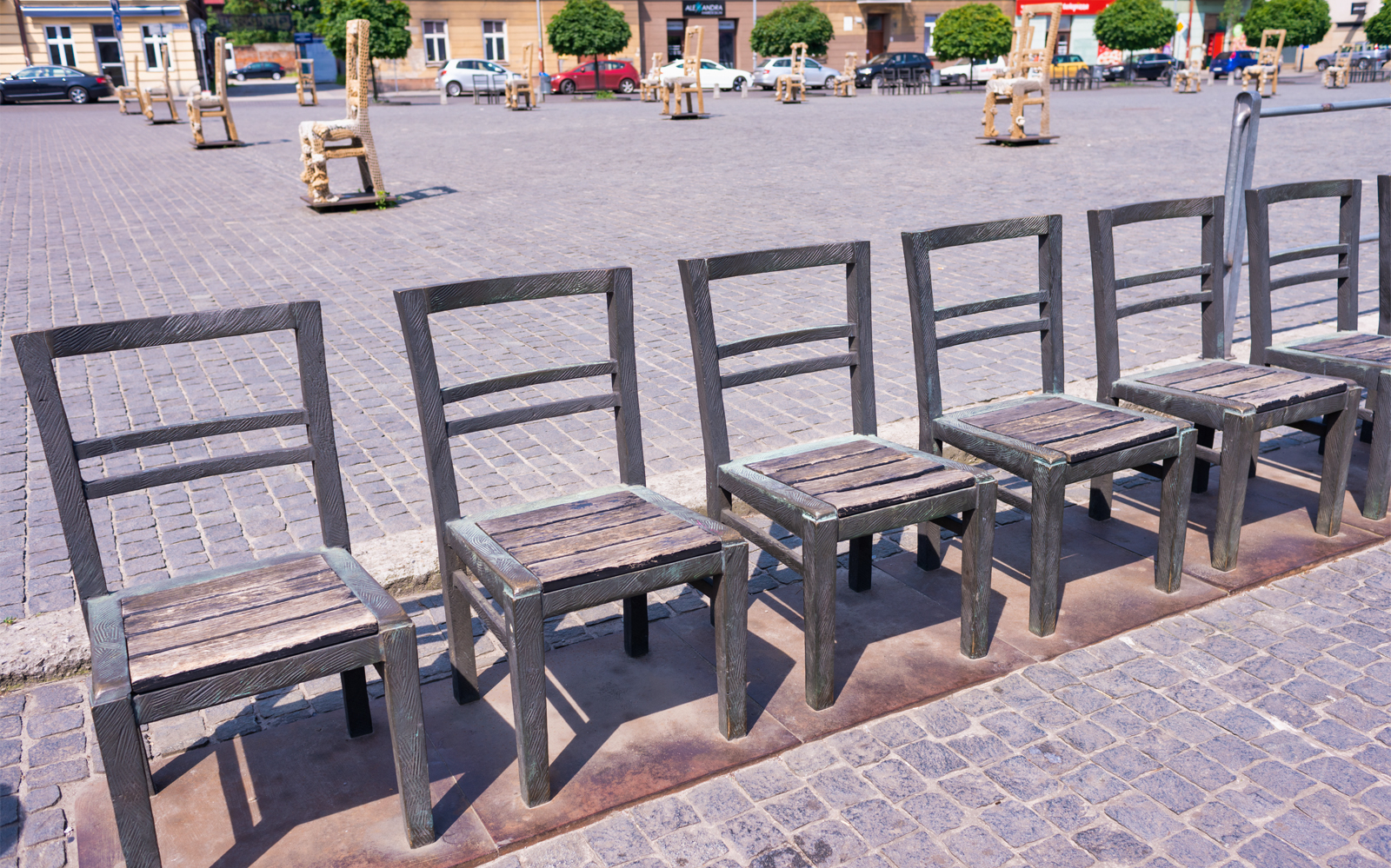 Empty chairs monument in Krakow Ghetto Heroes Square, part of guided tour.