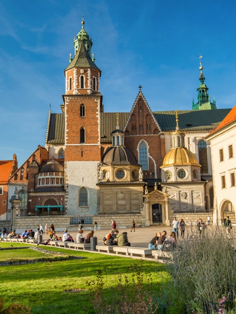 Wawel Castle and Cathedral in Krakow with visitors exploring the grounds.