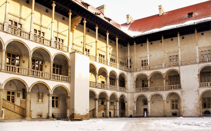 Wawel Castle courtyard with arched balconies in Krakow, Poland.