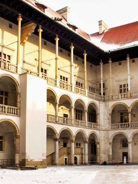 Wawel Castle courtyard with arched balconies in Krakow, Poland.