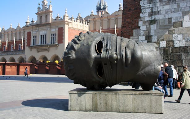 Bronze head sculpture in Krakow's Main Square on the Royal Route tour.