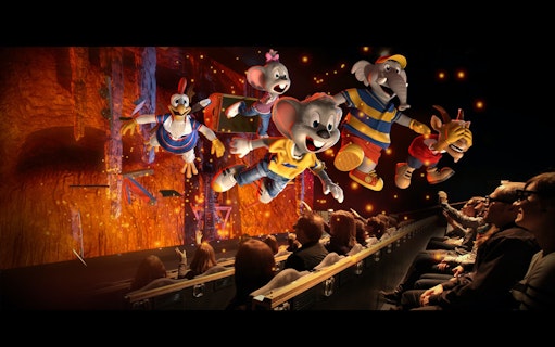 Animated characters flying in a 4D theater experience at Sentosa, audience wearing 3D glasses.