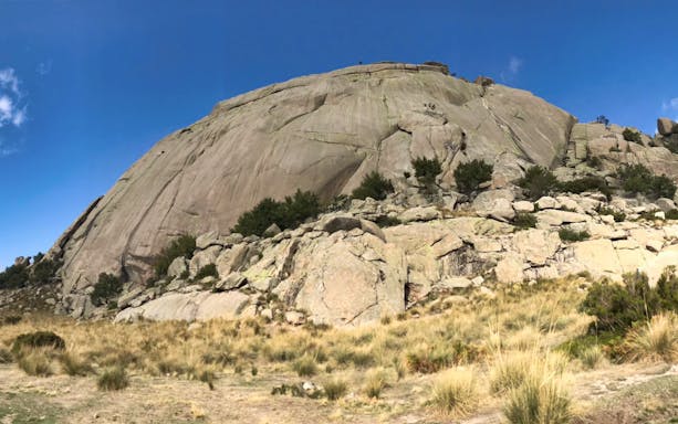 Rocky landscape in Guadarrama National Park, Madrid, under clear blue sky.