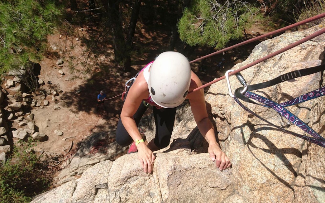 Rock climber ascending a cliff in Guadarrama National Park, Madrid.