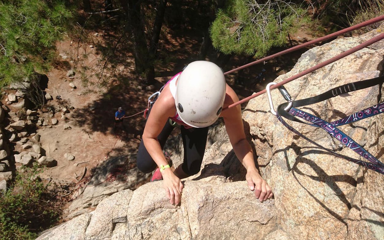 Rock climber ascending a cliff in Guadarrama National Park, Madrid.