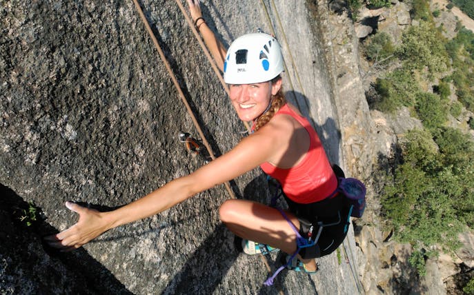 Rock climber scaling a cliff in Guadarrama National Park, Madrid.