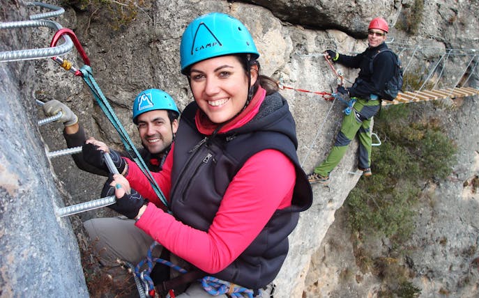 Climbers on Via Ferrata Boca del Infierno in Madrid, secured with harnesses and helmets.