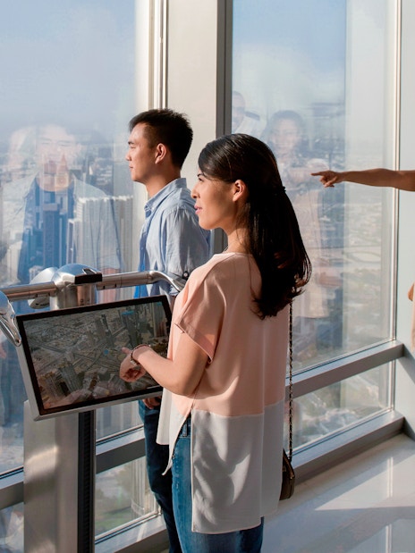 Tourists viewing Dubai skyline from Burj Khalifa Levels 124 and 125.