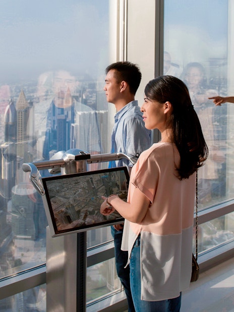Tourists viewing Dubai skyline from Burj Khalifa Levels 124 and 125.