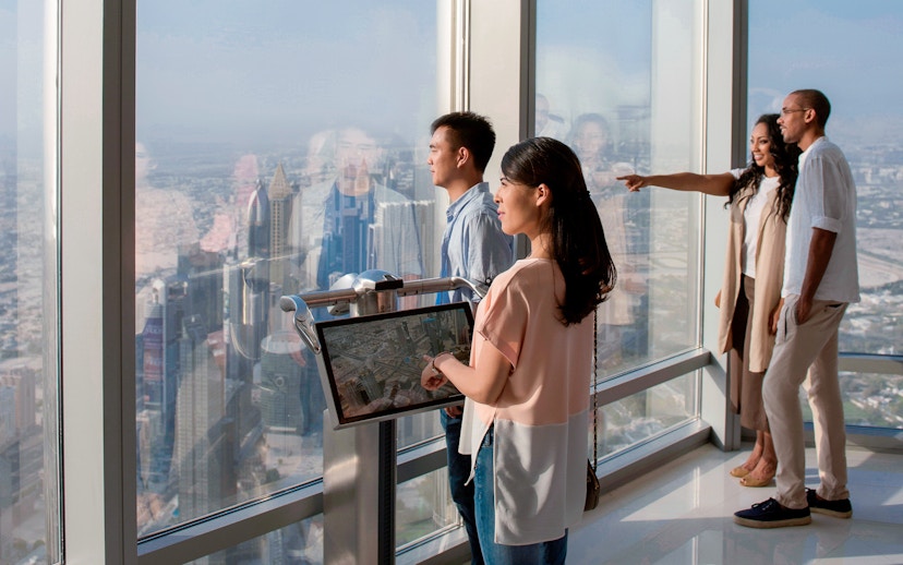 Tourists viewing Dubai skyline from Burj Khalifa Levels 124 and 125.
