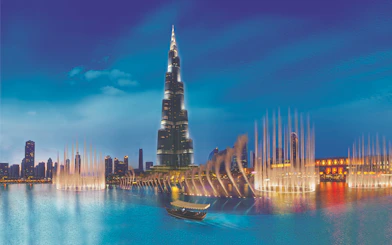 Burj Khalifa and Dubai Fountain at night, view from the water.