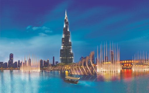 Burj Khalifa and Dubai Fountain at night, view from the water.