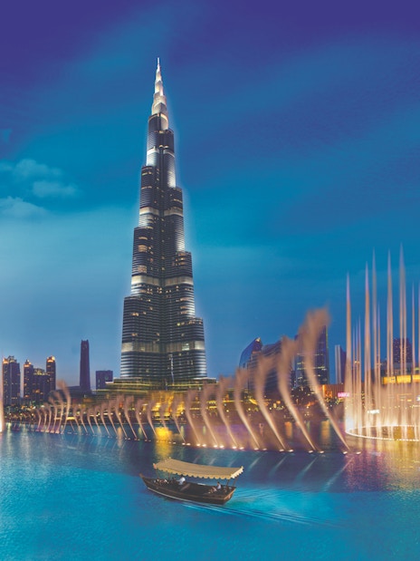 Burj Khalifa and Dubai Fountain at night, view from the water.