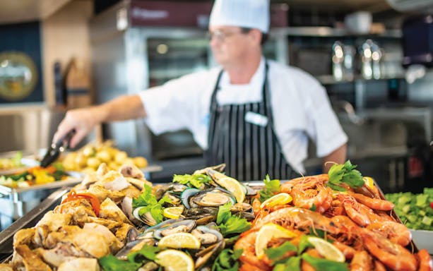 Chef preparing seafood platter on Sea World dinner cruise.