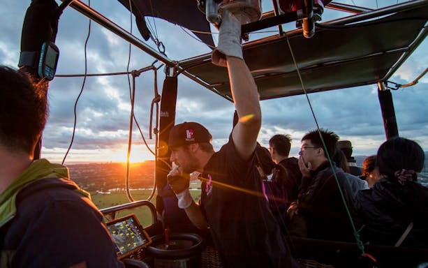 Hot air balloon passengers enjoy sunrise views during a 60-minute ride.